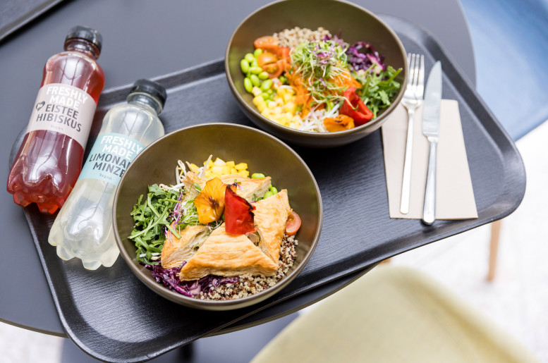 Zwei Bowls mit frischem Lunch auf einem Plateu mit Getränken